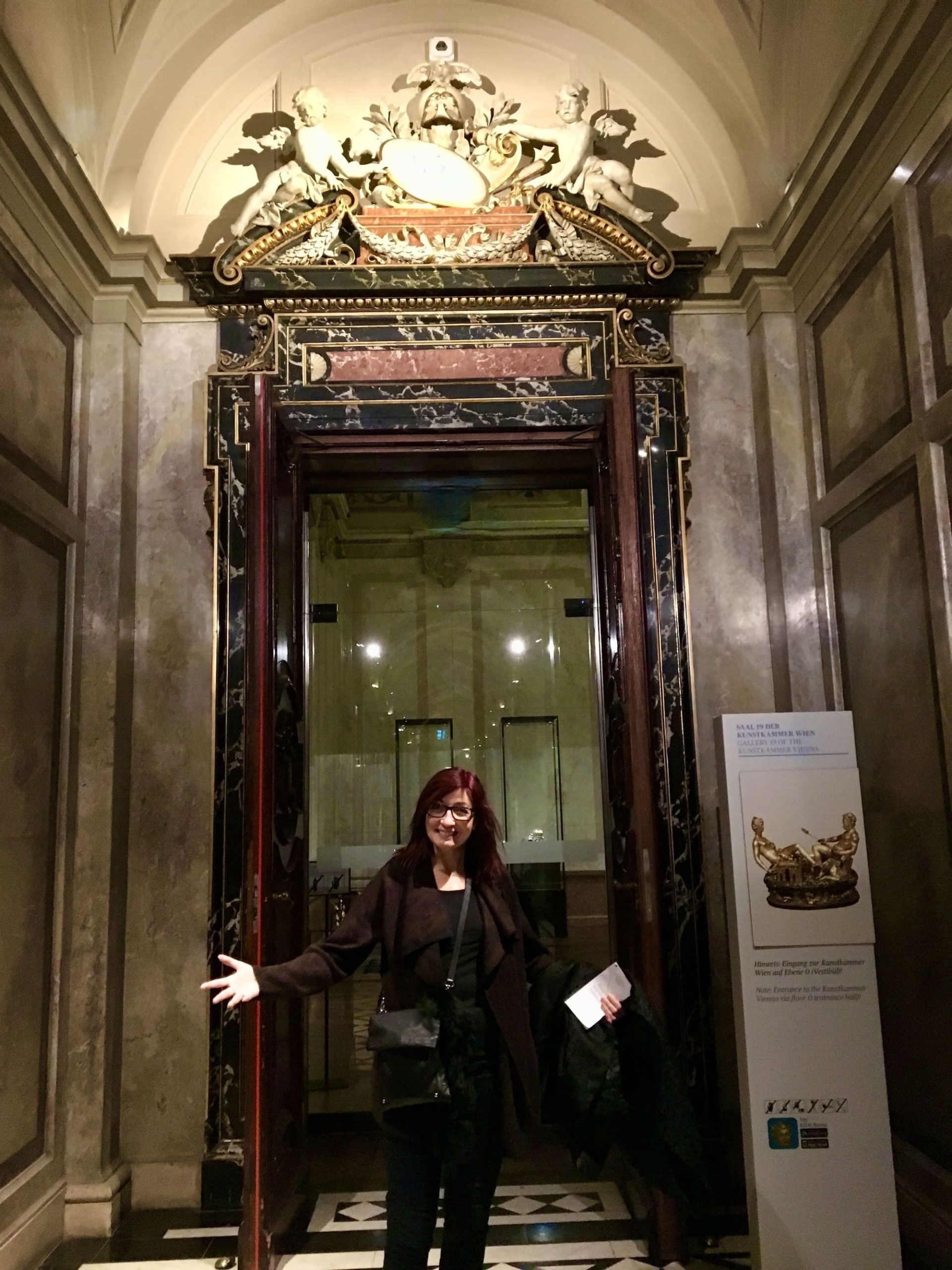 Woman standing in ornate Kunsthistorisches Museum entrance showcasing Vienna's dedication to preserving artistic treasures