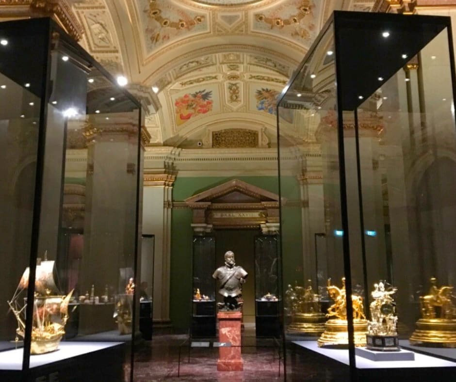 Museum gallery with illuminated display cases protecting precious artifacts for future generations to discover
