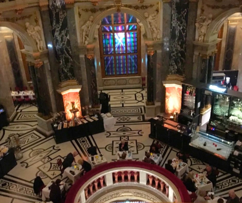 Grand museum rotunda viewed from above showing diners in spaces dedicated to preserving human creativity